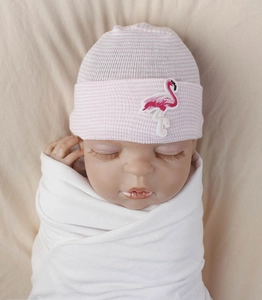 Detailed view of pink striped baby knit hat with flamingo embroidery on a model head