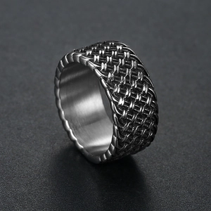 Detailed view of wide men's stainless steel ring with woven mesh texture and brushed interior