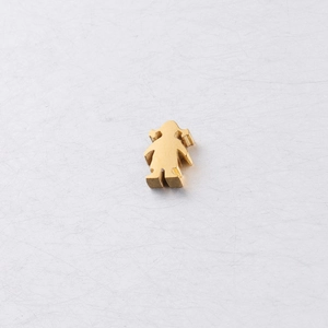 Close-up of golden stainless steel girl-shaped charm bead for DIY jewelry making