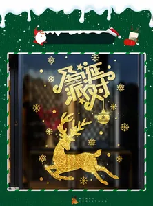 Close-up of golden glitter Christmas deer and snowflake window stickers on glass