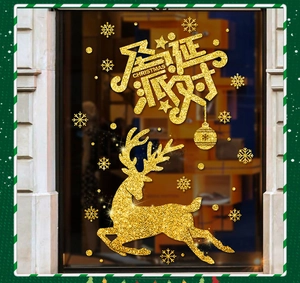 Macro detail of golden glitter reindeer and snowflake decals on a shop window