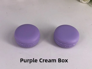 Detail view of two purple macaron shaped cream jars with frosted plastic texture and lid