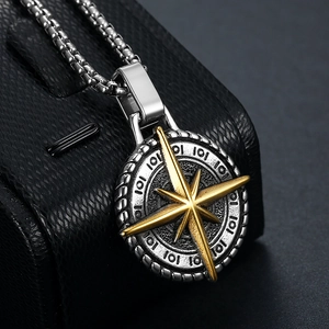 Macro detail of nautical compass pendant necklace in gold and silver finish