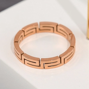 Elegant rose gold titanium steel ring with hollow Greek key pattern in polished finish