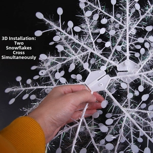 Close-up of 3D white snowflake pendant showing the interlocking installation process
