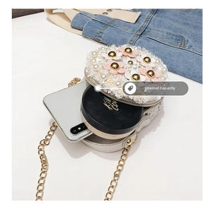 Internal capacity of kids floral crossbody bag showing space for phone and compact