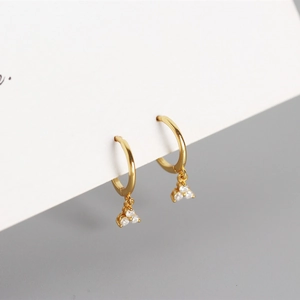 Close-up of gold S925 sterling silver geometric hoop earrings with sparkling zircon charms