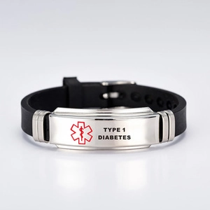 Macro view of Type 1 Diabetes medical alert ID tag on adjustable black silicone bracelet
