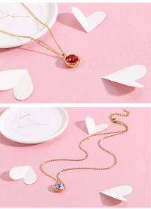 Detail of 18k gold-plated necklaces with red and purple round crystal pendants