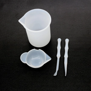 Macro detail of 4-piece silicone measuring and mixing tools set for resin casting DIY