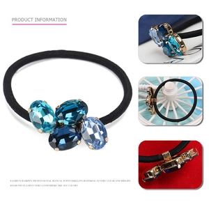 Detailed view of handmade blue oval crystal hair tie with golden metal base