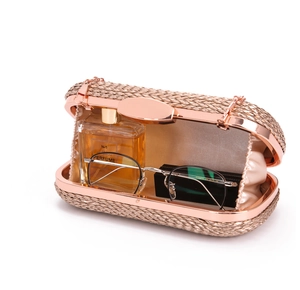 Interior view of the woven evening bag showing capacity for perfume and accessories