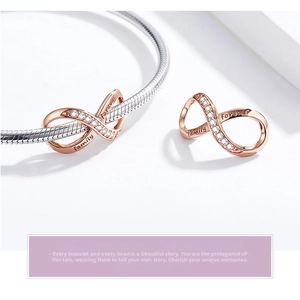 Detail of rose gold infinity charm with white diamonds and forever family engraving