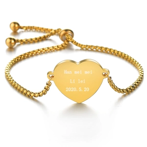 Macro detail of personalized golden heart pendant with custom name and date engraving