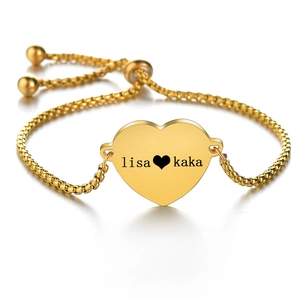 Detailed view of custom engraved gold heart bracelet with adjustable slider chain closure