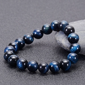 Close-up of natural blue tiger eye stone beads bracelet with polished cat eye effect