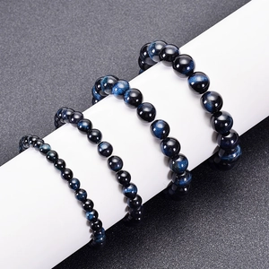 Natural deep blue tiger eye stone bead bracelets in various sizes on white cylinder