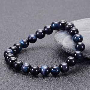 Macro detail of natural blue tiger eye stone bracelet beads with silk luster finish