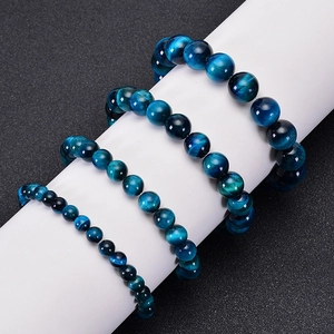 Detail showing three different bead sizes of blue tiger eye stone bracelets on a stand
