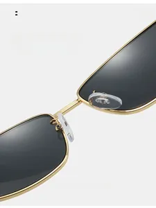 Macro detail of ergonomic silicone nose pads on sleek gold metal frame sunglasses