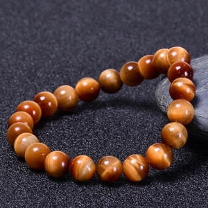 Detailed view of natural tiger eye stone beaded bracelet with warm brown chatoyancy