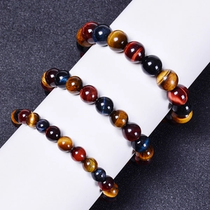 Three-color natural tiger eye stone bracelet with yellow, red, and blue beads on a black background