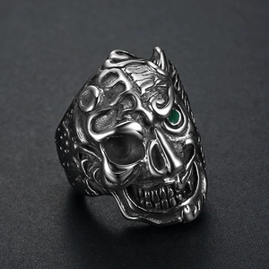 Vintage stainless steel skull ring with green gemstone eyes and gothic punk style