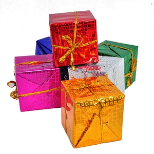 Macro view of colorful glitter gift box ornaments with gold ribbons for Christmas tree
