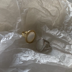 Detail of vintage shell rings in gold and silver finish with adjustable open bands