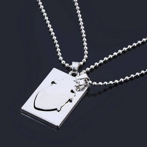 Silver heart pendant necklace on bead chain over dark reflective background