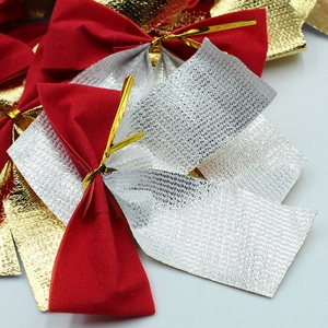 Detail view of red flocking and gold mesh Christmas tree bow ornaments stacked together