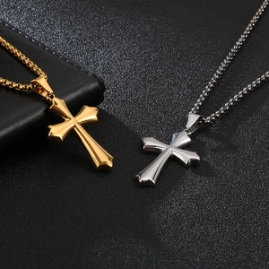 Mens stainless steel cross pendants in gold and silver finishes on black background