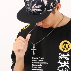 Male model wearing a classic silver stainless steel cross pendant necklace on white background