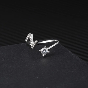 Detailed macro shot of adjustable silver ring with letter N design and pavé crystals