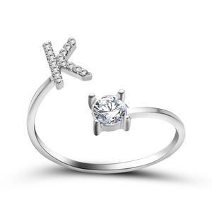 Detail of adjustable silver ring featuring a micro-paved letter K and round cubic zirconia