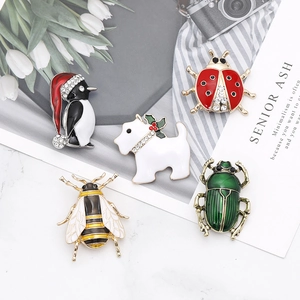 Five assorted animal enamel brooches featuring penguin, dog, ladybug, bee, and beetle designs