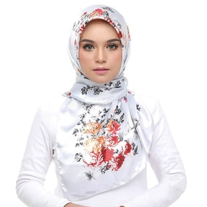 Close-up of silk satin square scarf with elegant red and orange floral chain print