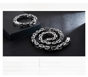 Detail of masculine stainless steel Byzantine woven chain necklace and bracelet set
