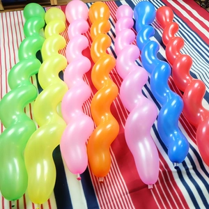 Set of seven colorful spiral latex balloons for KTV party decoration on striped fabric
