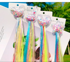 Close-up of glitter-filled hair clips with vibrant rainbow gradient synthetic hair extensions