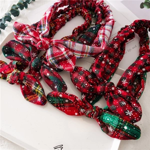 Detailed set of four Christmas knotted headbands with snowflake prints and festive plaid