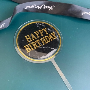 Acrylic happy birthday cake topper detail, black marble pattern with gold rim insert design.