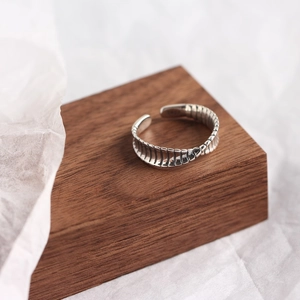 Macro detail of S925 sterling silver twisted ring with vintage bone structure texture