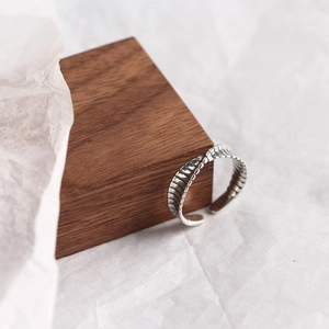 Macro detail of S925 sterling silver twisted ring with unique leaf-like textured finish