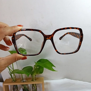 Detailed close-up of retro tortoiseshell square glasses frame in a wide-frame design