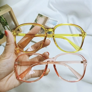 Close-up of candy-colored transparent eyewear frames with printed size specifications