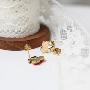 Detail shot of cherry-shaped Mickey stud earrings with 14K gold plating and red finish