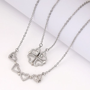 Silver four-leaf clover folding necklace with heart accents and sparkling crystals