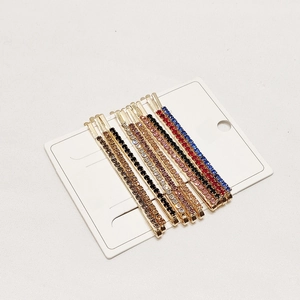 Detailed set of eight golden hair clips with vibrant colorful rhinestone embellishments