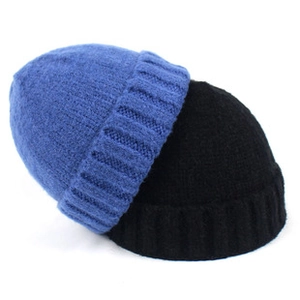Detailed close-up of blue and black knitted beanies showing premium elastic texture
